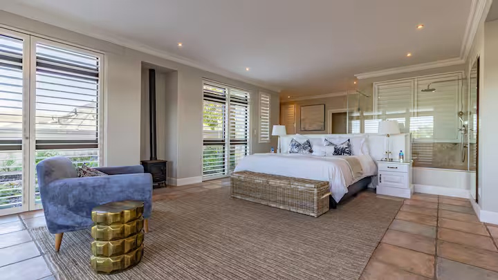 Spacious guest suite with king bed and open shutters