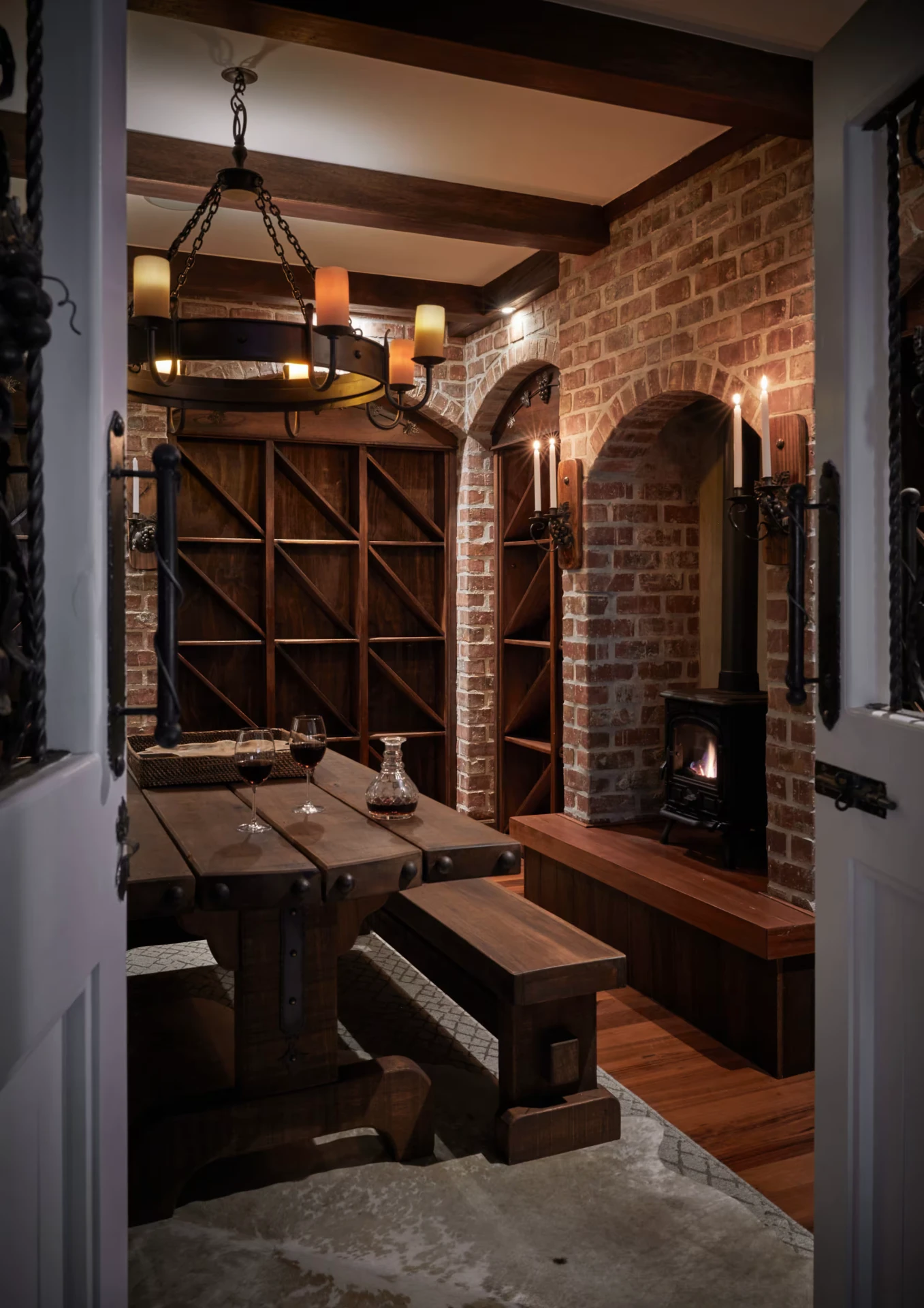 Candlelit wine cellar with tasting table and wood-burning stove