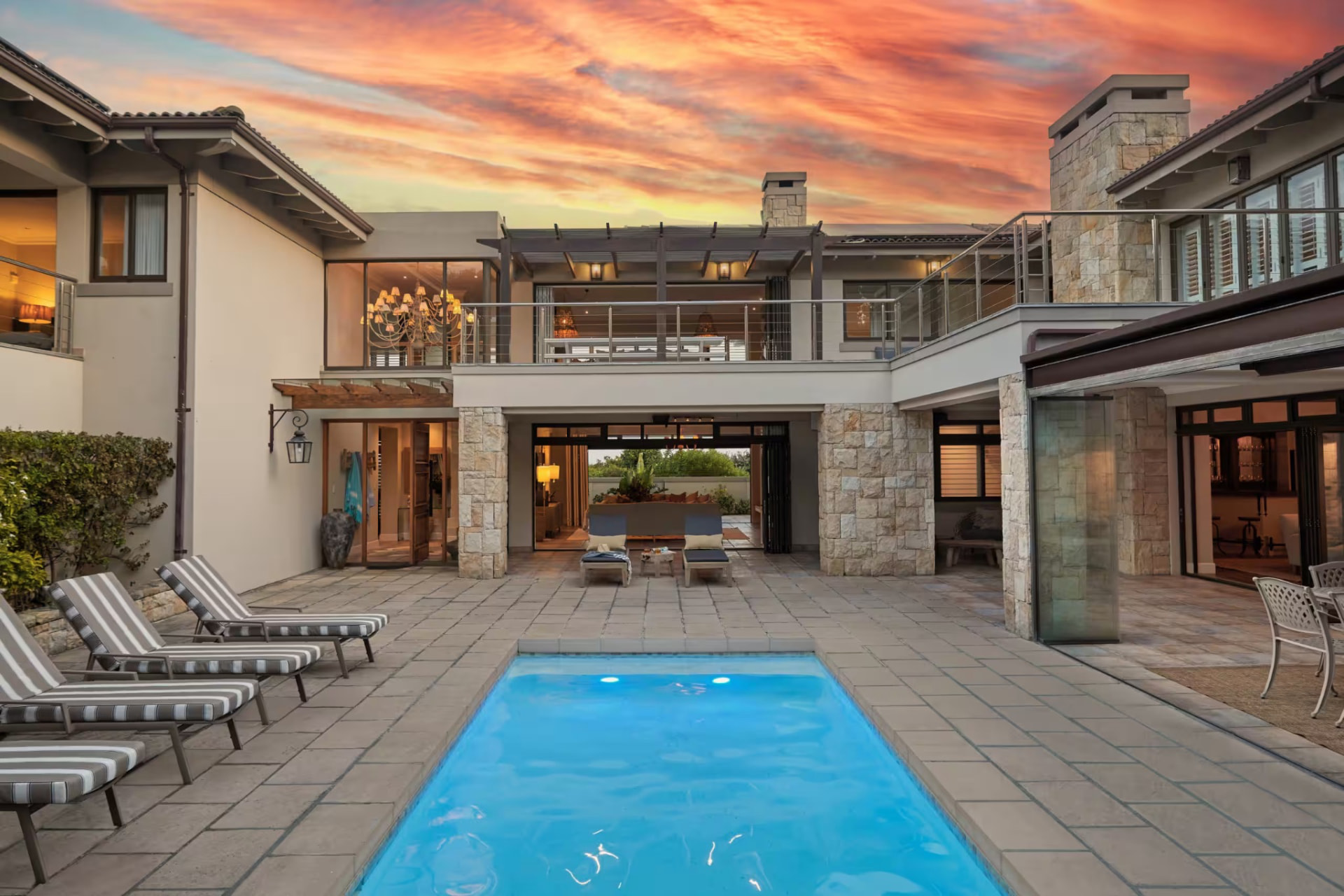 Front of the villa and pool at sunset